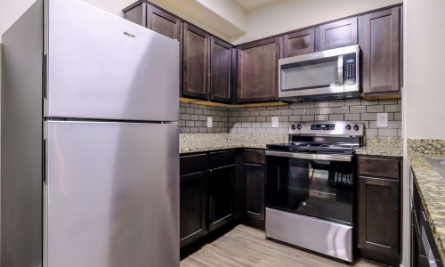 a kitchen with black appliances
