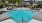 a pool with chairs around it