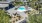 a pool and lounge chairs in a backyard