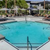 a pool with chairs and tables around it
