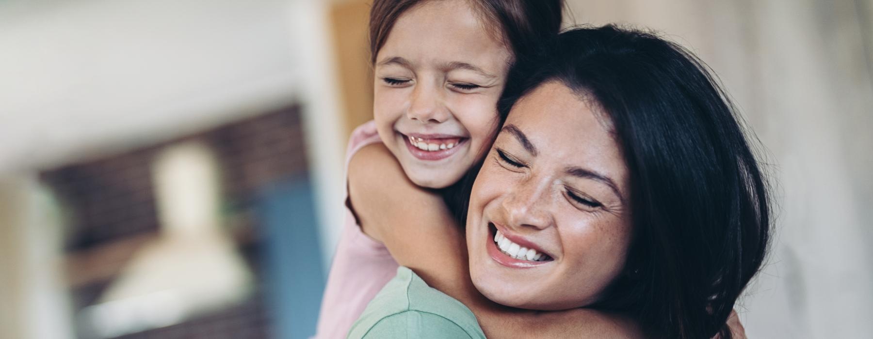 a woman hugging another woman