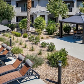 Relax and unwind poolside a patio with chairs and umbrellas