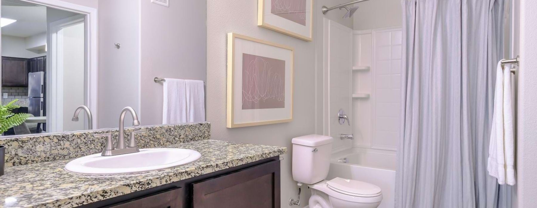 a bathroom with a sink toilet and a mirror