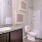 a bathroom with a sink toilet and a mirror